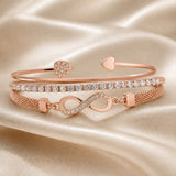 Set witgouden armbanden met strass en oneindigheidssymbool