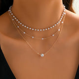 Driedubbele ketting met lagen parels