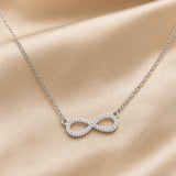 Witgoudkleurige ketting met oneindigheidshanger en zirkonia