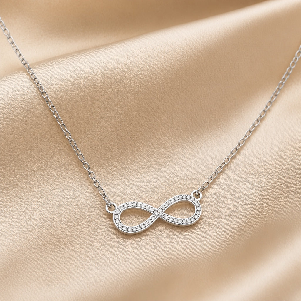 Witgoudkleurige ketting met oneindigheidshanger en zirkonia